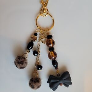 Elegant Black and Gold Bag Charm with Bow